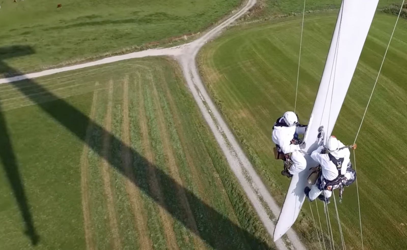 workers dangling from blade