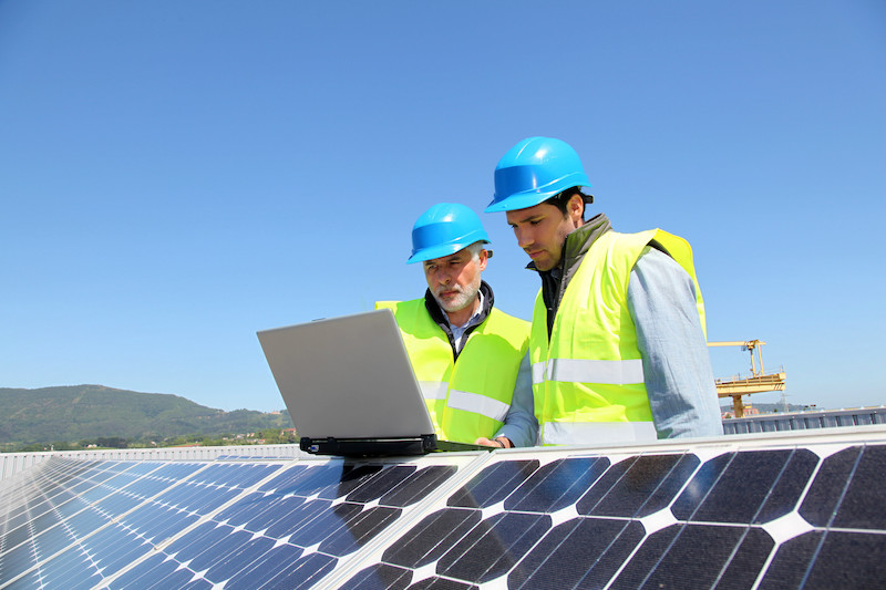 yellow vested solar workers