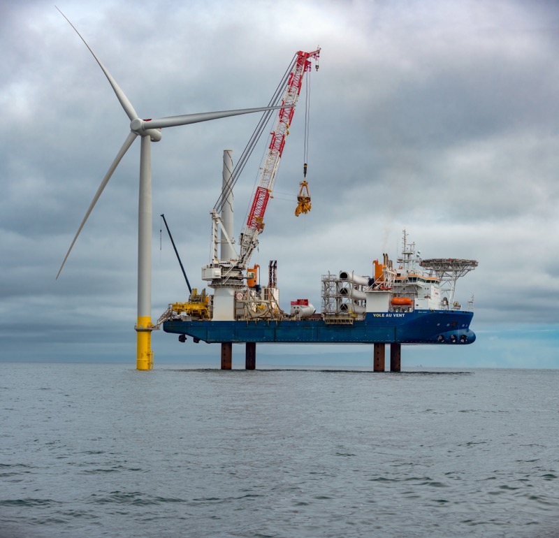cloudy offshore wind turbine with crane