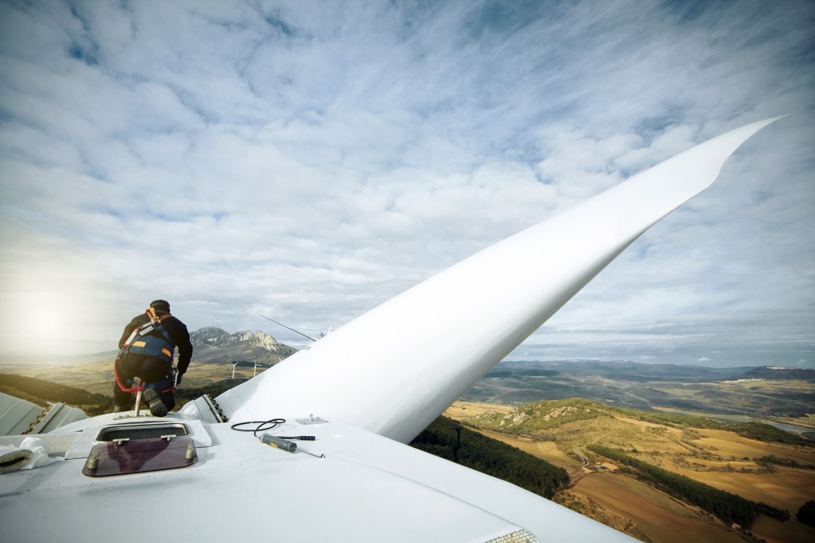 worker atop turbine