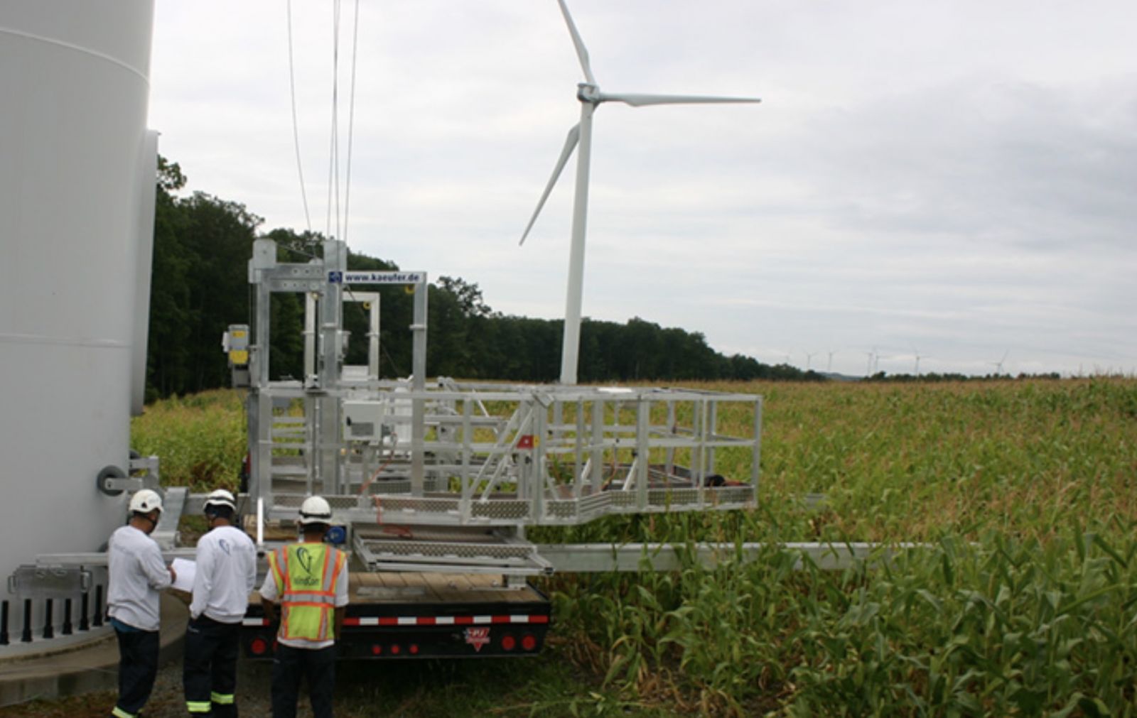 men in front of turbine