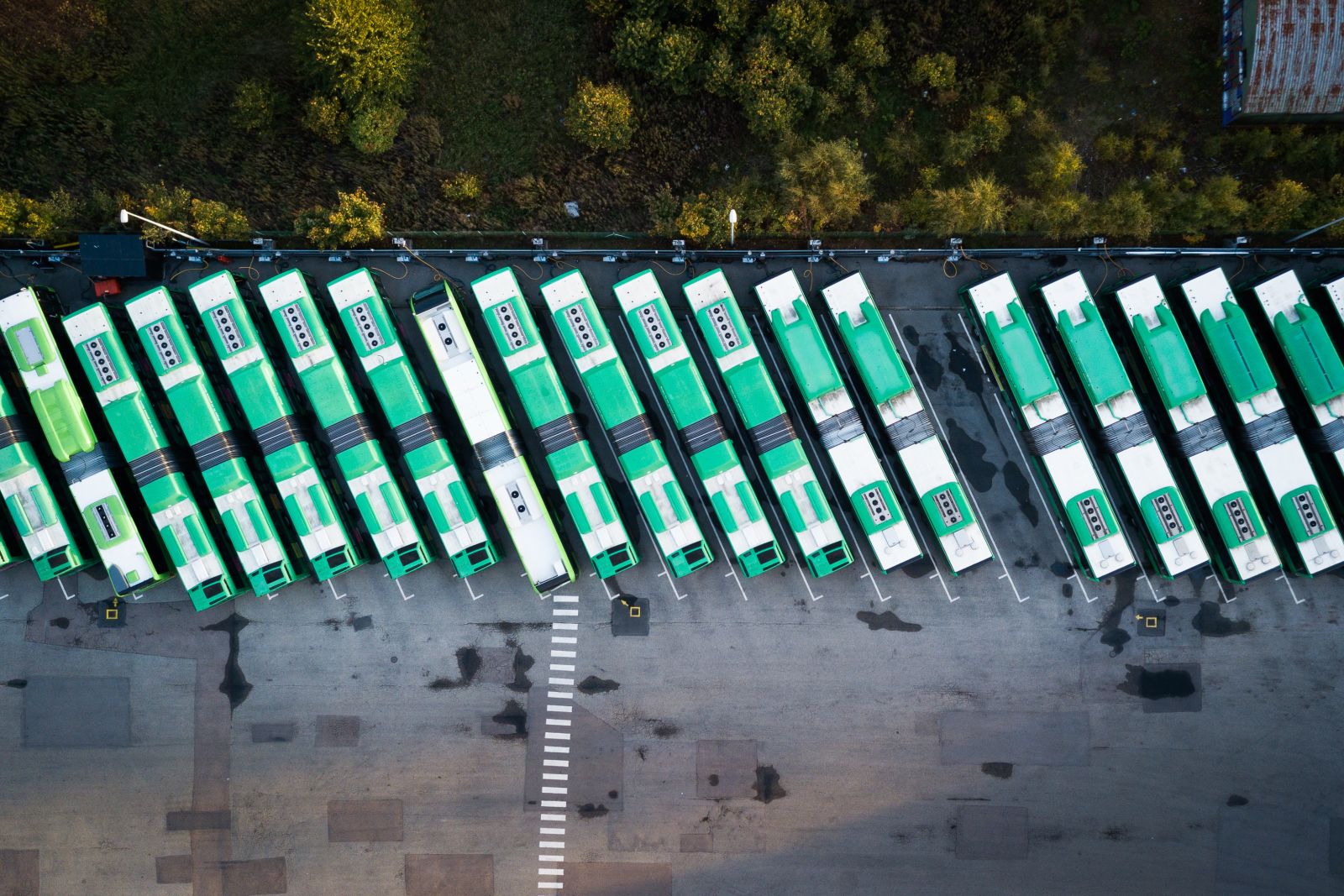 aerial shot lined up green ev buses