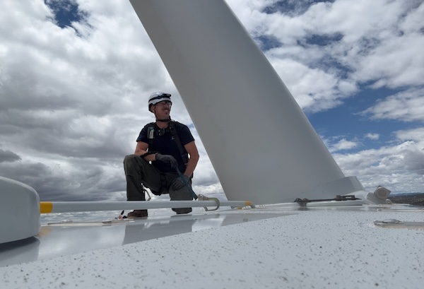 man atop turbine