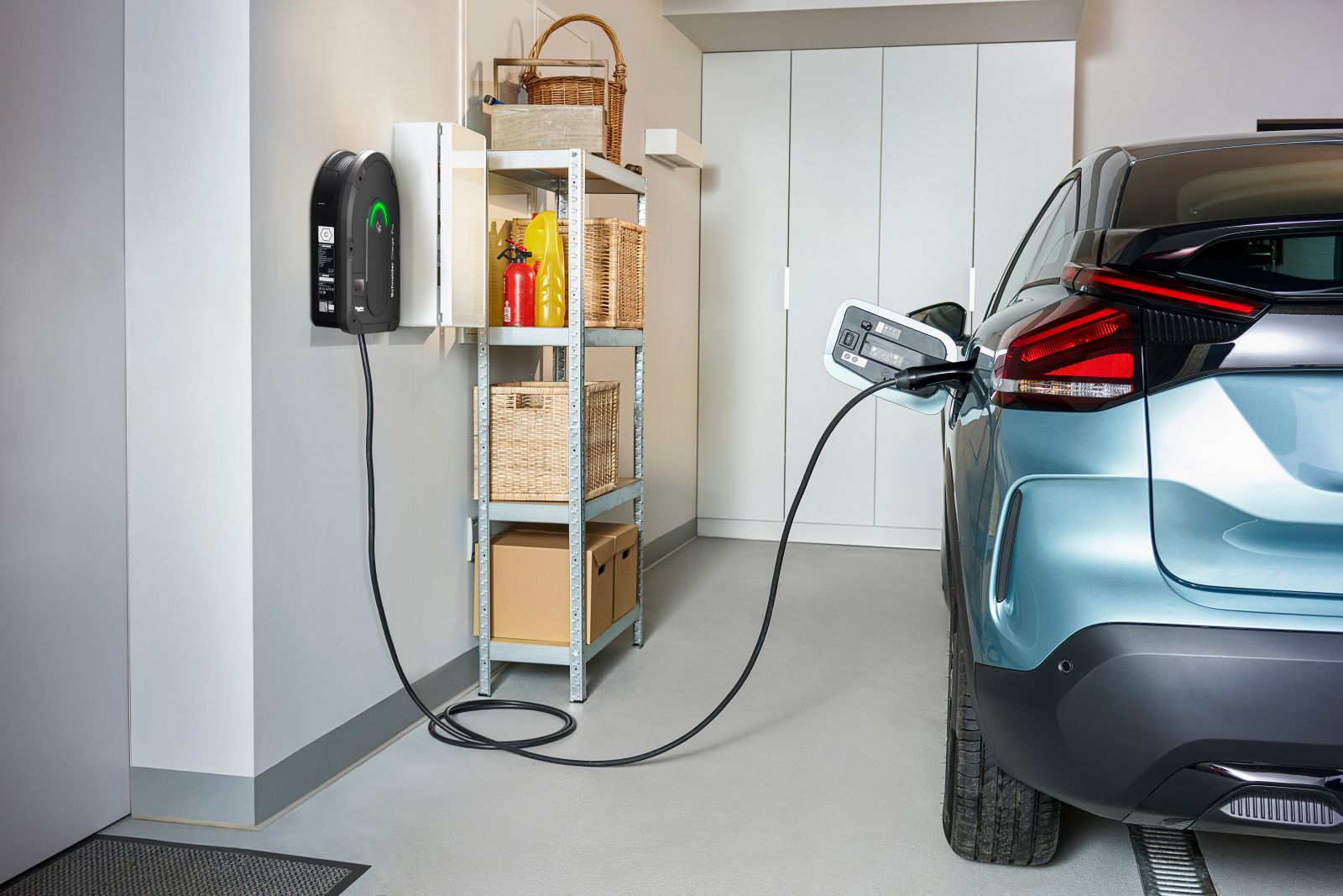 blue car charging in garage