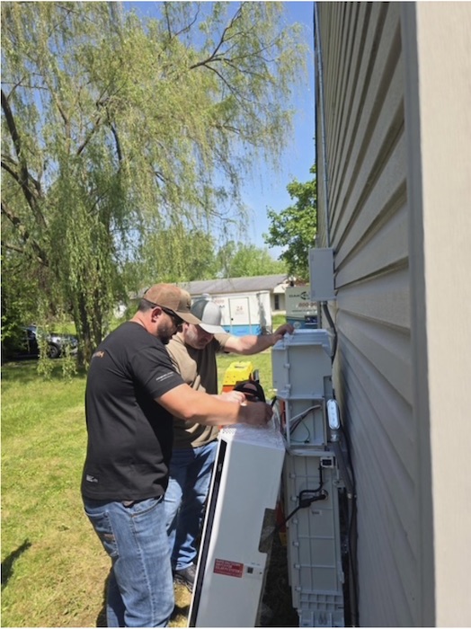 vertical men working side of house