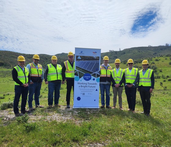 hardhats holding a sign