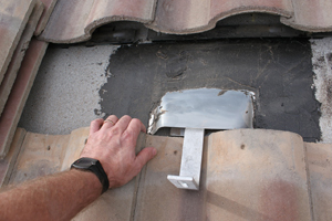 Figure 4. This tile mount from Quick Mount PV includes a preformed deck-level flashing, which is sealed to the underlayment using the 3-course method