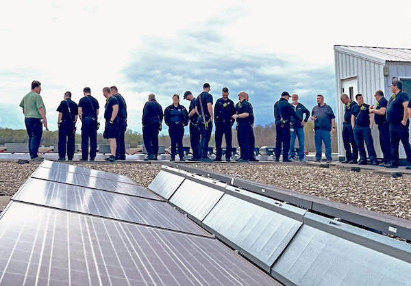 uniforms lined up by solar panel