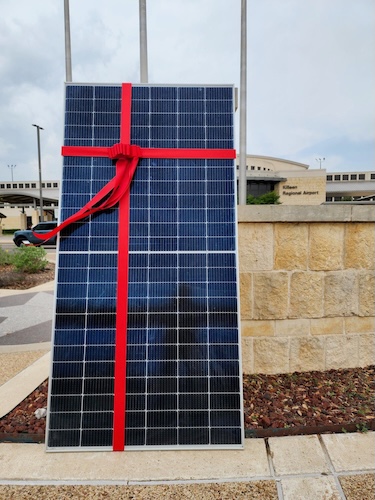 red ribbon wrapped solar panel
