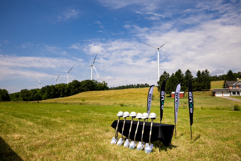 hard hats in front of turbine