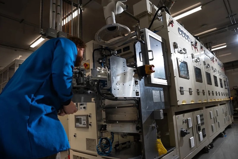 blue coat person with machine