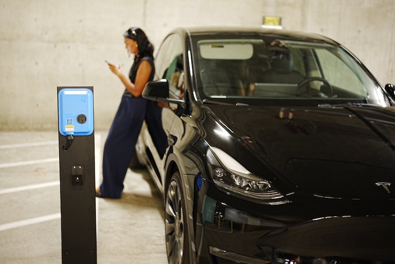 ev charger black car woman