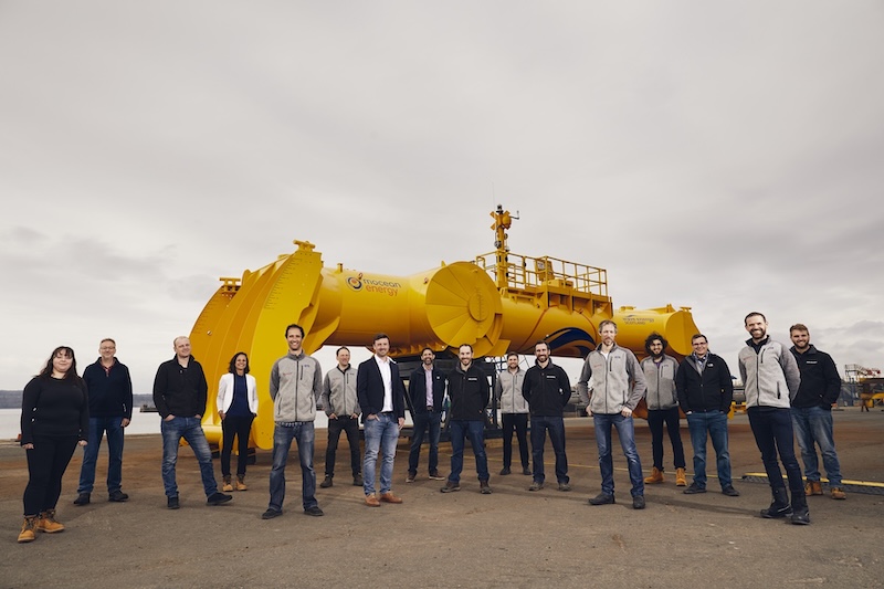 group shot in front of yellow machine