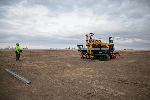 machine in field with person