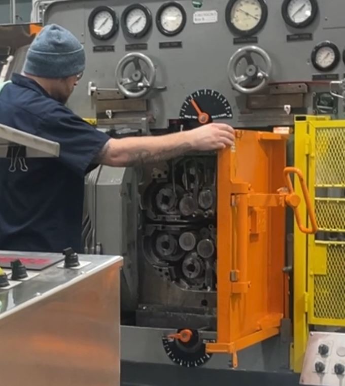 guy in hat at machine